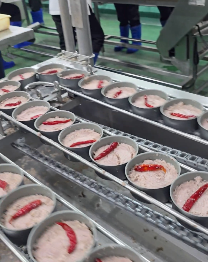 Industrial production line manufacturing tuna cans at Top Tide Canning